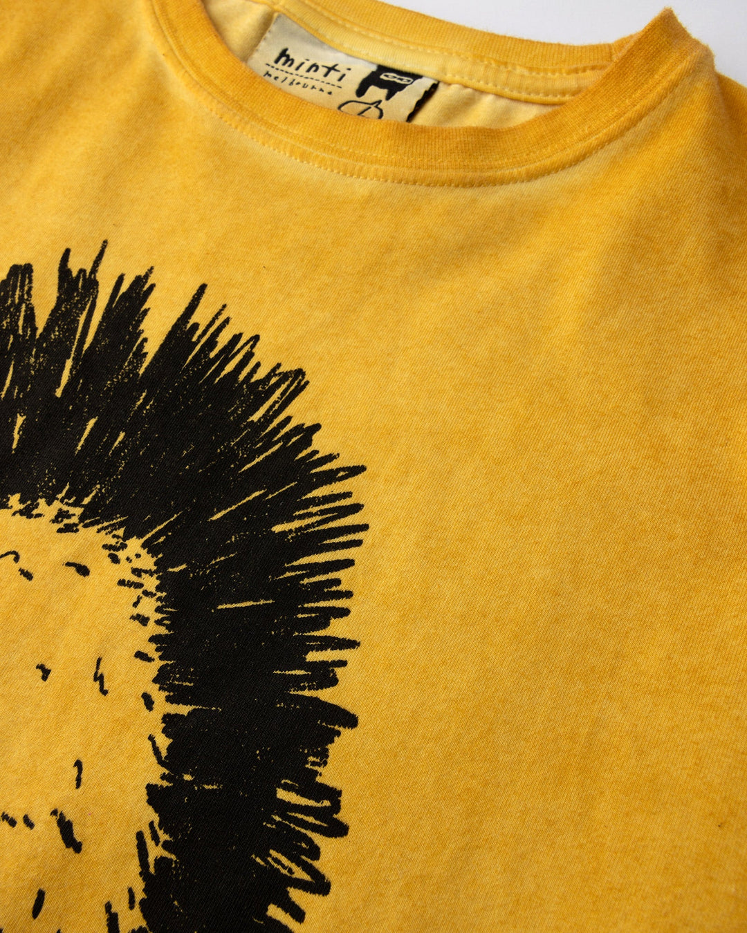 Close up of the Mo-Hawk Tee print in mustard wash