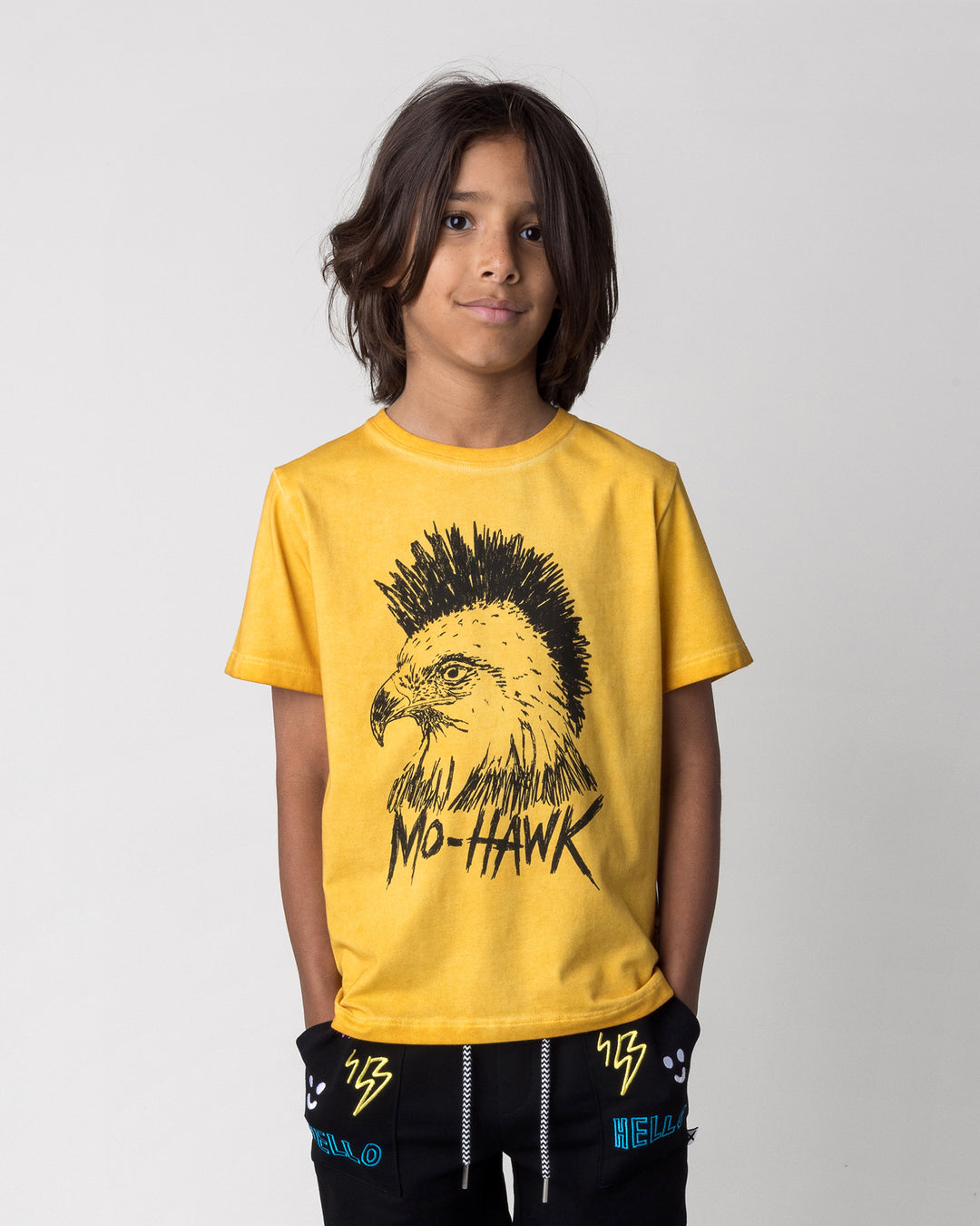Close up of the Mo-Hawk Tee in mustard wash on a kid, front view