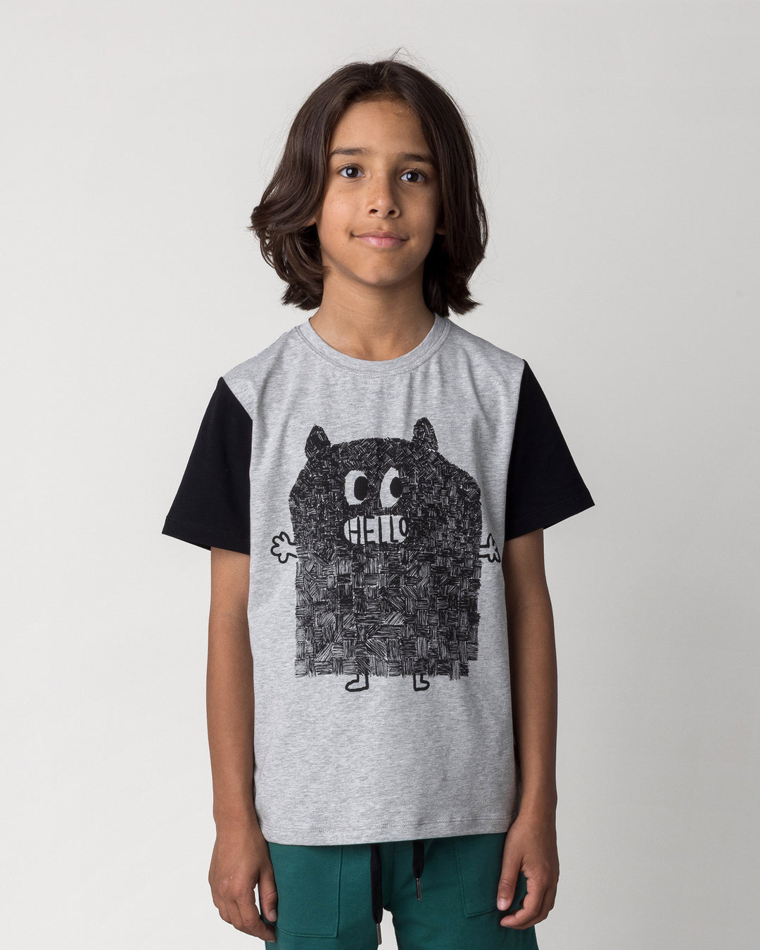 Close up of the Patchwork Monster Tee in grey marle and black on a kid, front view