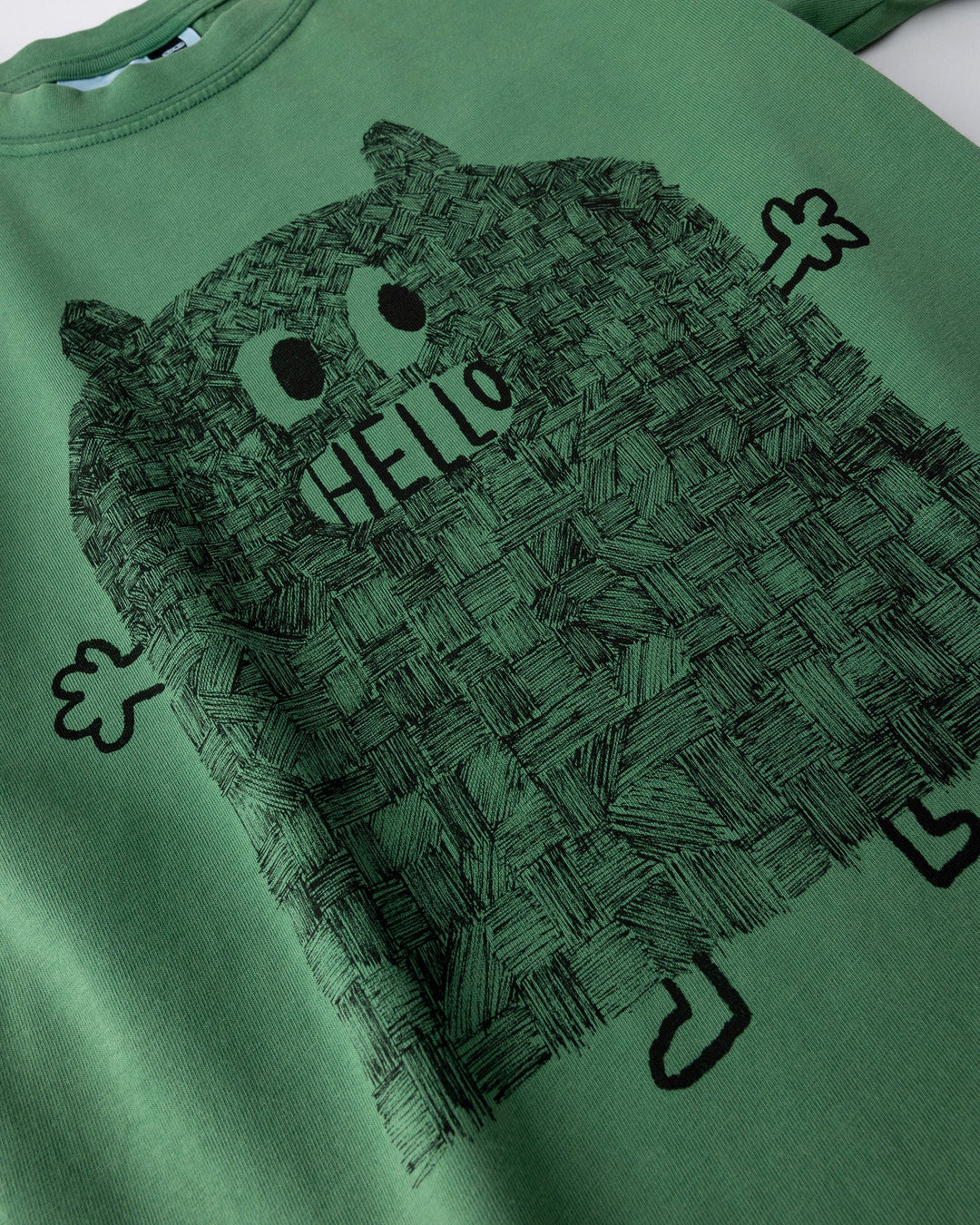 Close up of the Patchwork Monster Tee print in turf wash