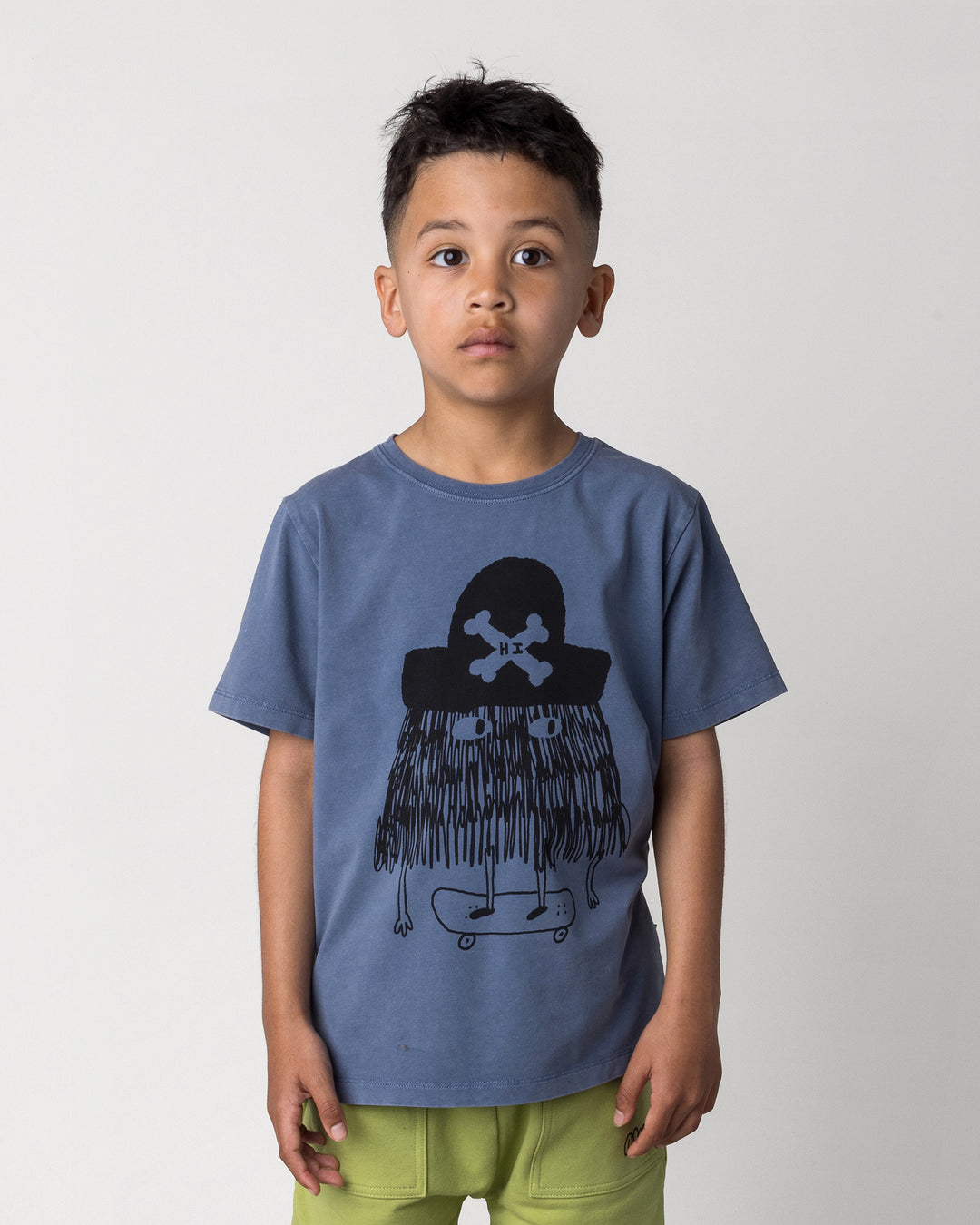 Close up of the Pirate Skater Tee in blue wash on a kid, front view