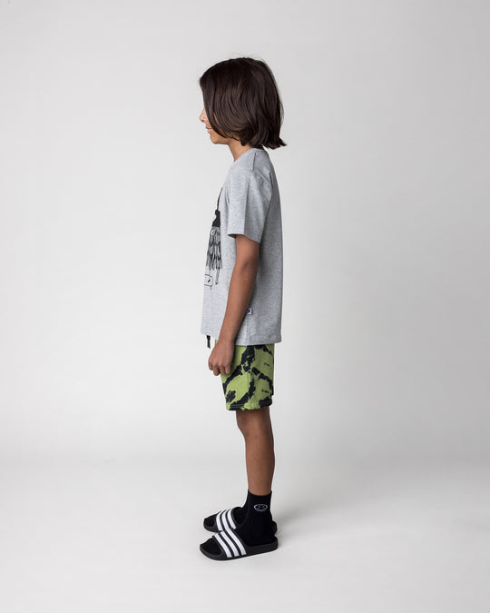 Kid wearing the Pirate Skater Tee in grey marle with the Strike Short in lime, side view