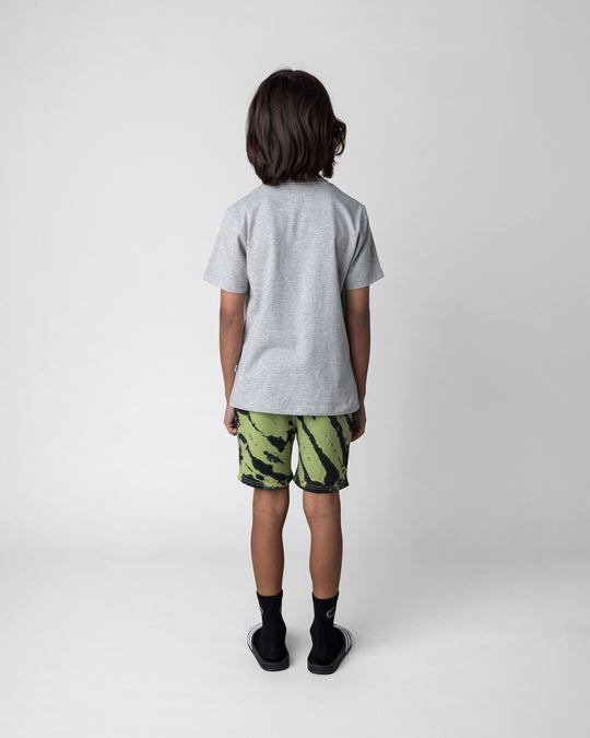 Kid wearing the Pirate Skater Tee in grey marle with the Strike Short in lime, back view