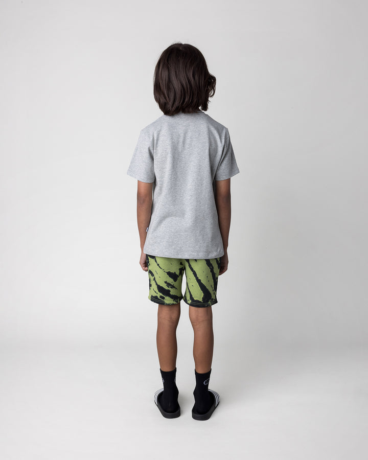 Kid wearing the Pirate Skater Tee in grey marle with the Strike Short in lime, back view