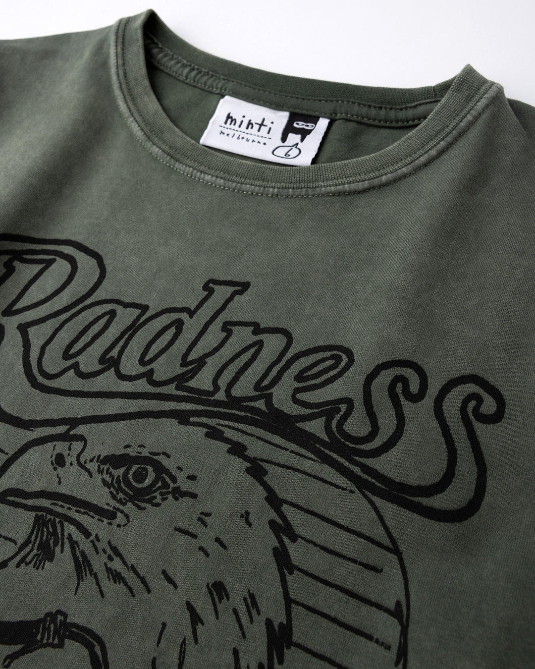 Close up of the Radness Tee print in olive wash