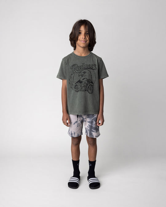 Kid wearing the Radness Tee in olive wash with the Splatter Short in grey, front view