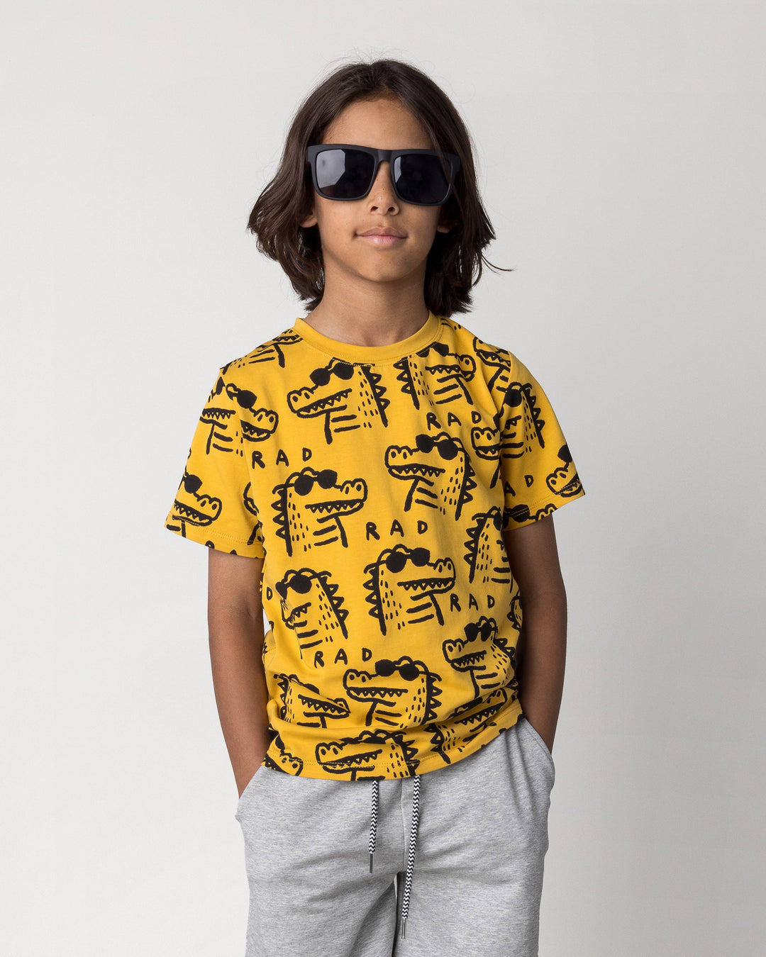 Close up of the Rad Croc Tee in mustard on a kid, front view