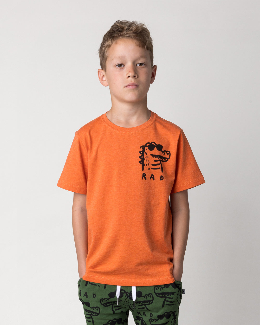 Close up of the Rad Croc Tee in orange marle on a kid, front view