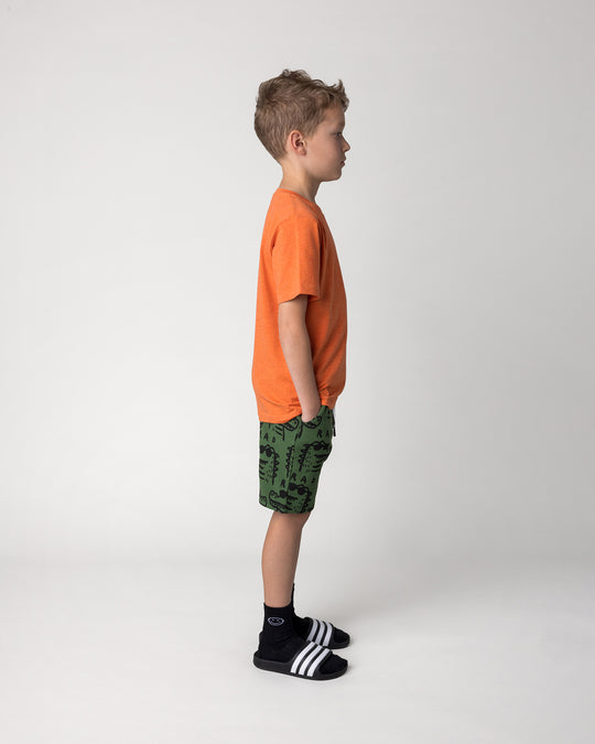 Kid wearing the Rad Croc Tee in orange marle with the Rad Croc Short in green, side view