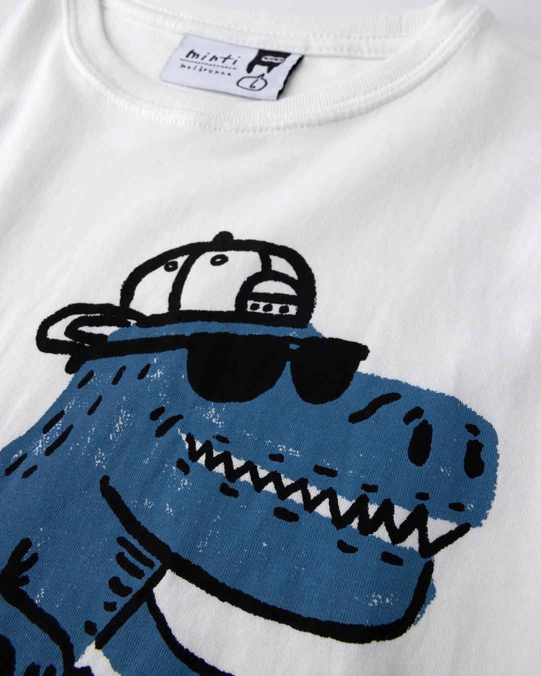 Close up of the Rex Rider Tee print in off white