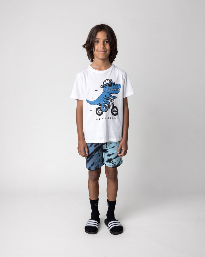 Kid wearing the Rex Rider Tee in off white with the Duo Tie Dye Short in blue and aqua, front view