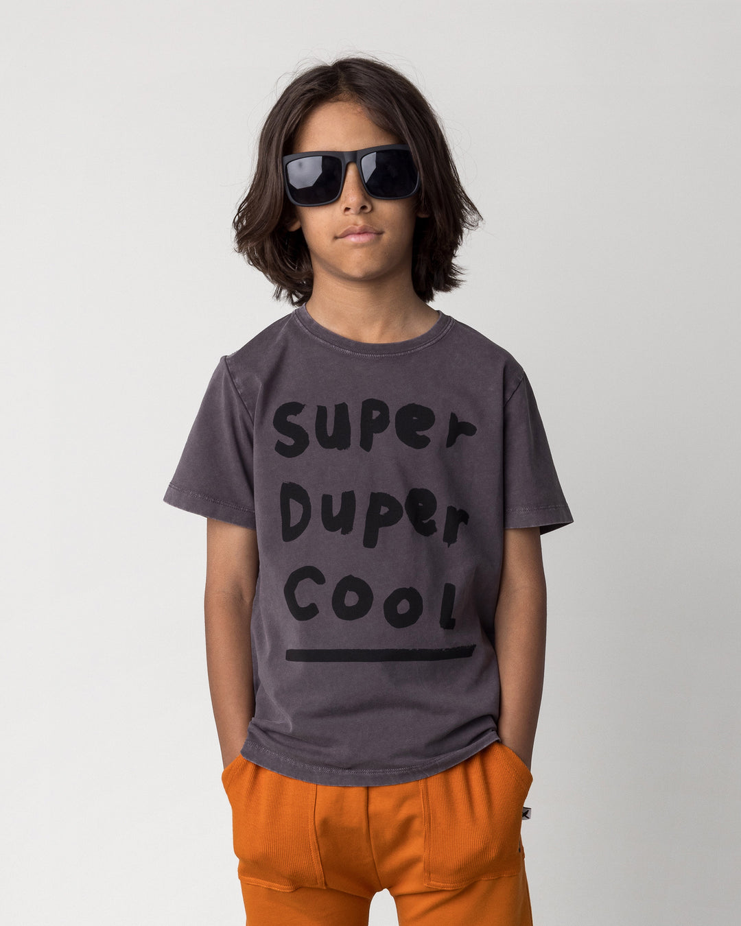 Close up of the Super Duper Cool Tee in black wash on a kid, front view
