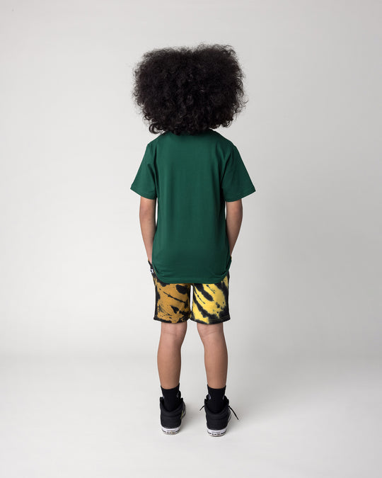 Kid wearing the Super Duper Cool Tee in jungle with the Duo Tie Dye Short in lemon and rust, back view