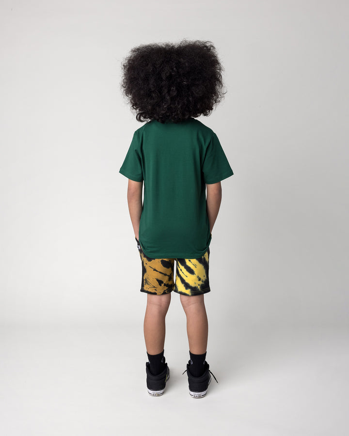 Kid wearing the Super Duper Cool Tee in jungle with the Duo Tie Dye Short in lemon and rust, back view