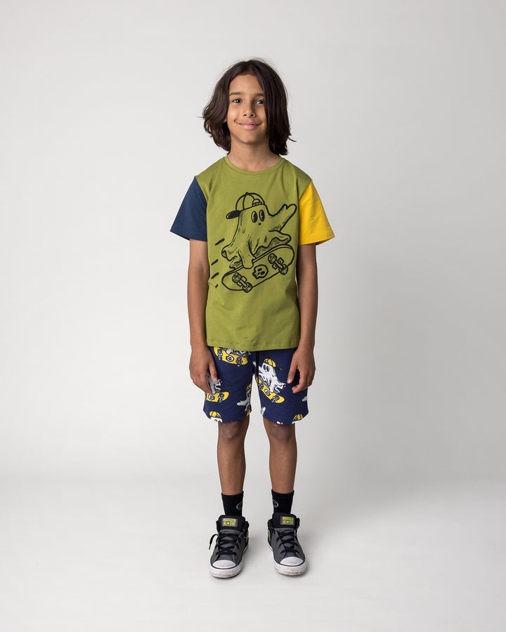 Kid wearing the Skate Ghost Tee in olive, ink and mustard with the Skate Ghost Short in dark blue, front view