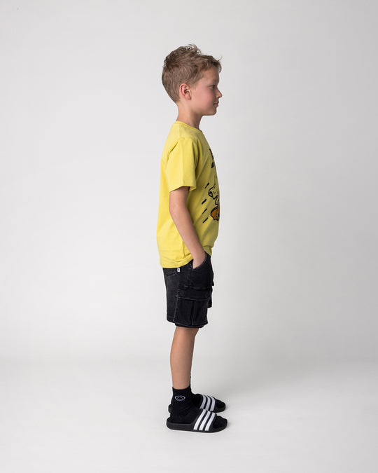 Kid wearing the Skate Ghost Tee in zest, side view
