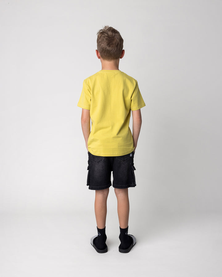 Kid wearing the Skate Ghost Tee in zest, back view