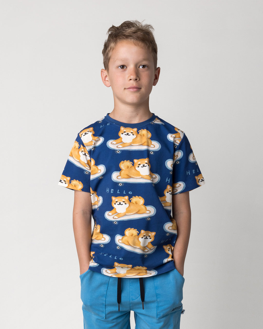 Close up of the Skate Puppy Tee in midnight on a kid, front view