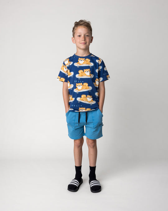 Kid wearing the Skate Puppy Tee in midnight with the Blasted Track Short in sky wash, front view