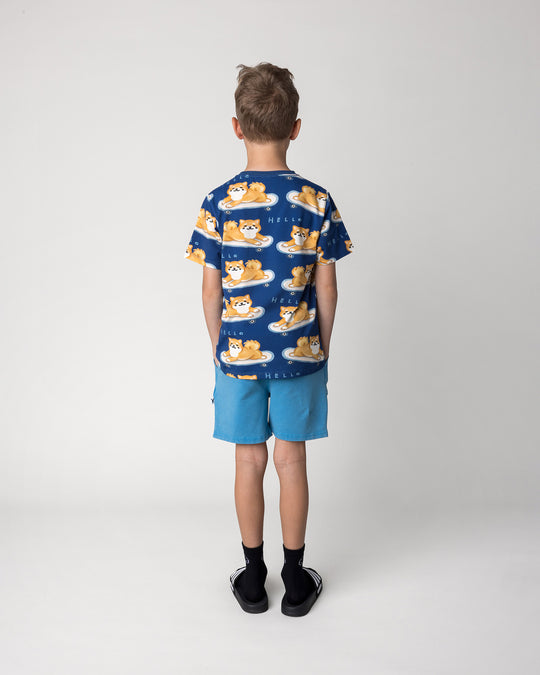Kid wearing the Skate Puppy Tee in midnight with the Blasted Track Short in sky wash, back view
