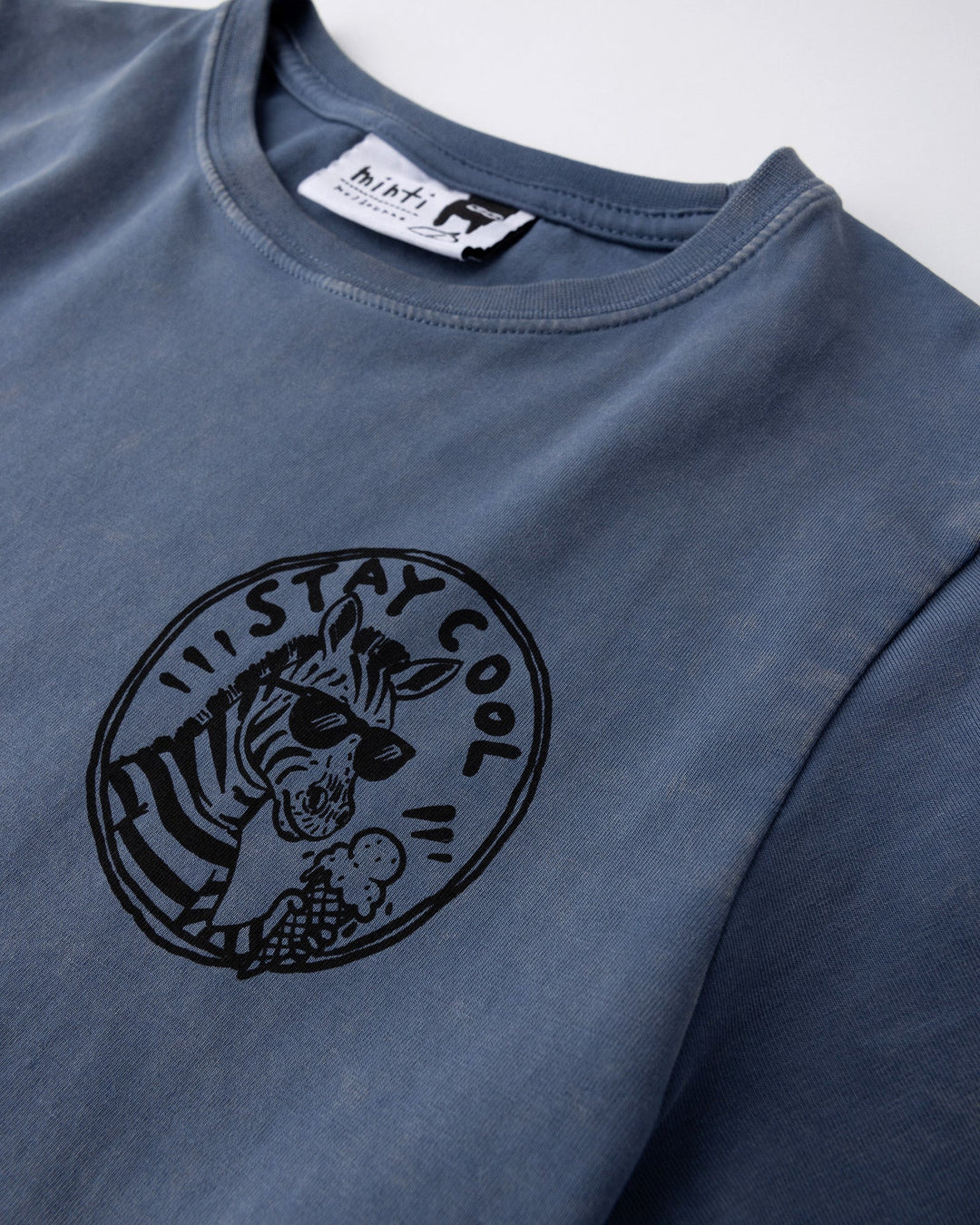 Close up of the Stay Cool Tee print in blue wash
