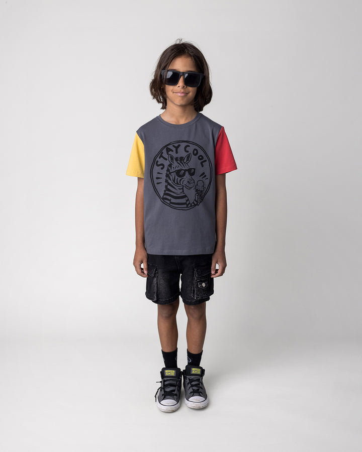 Kid wearing the Stay Cool Tee in dark grey, yellow and melon, front view