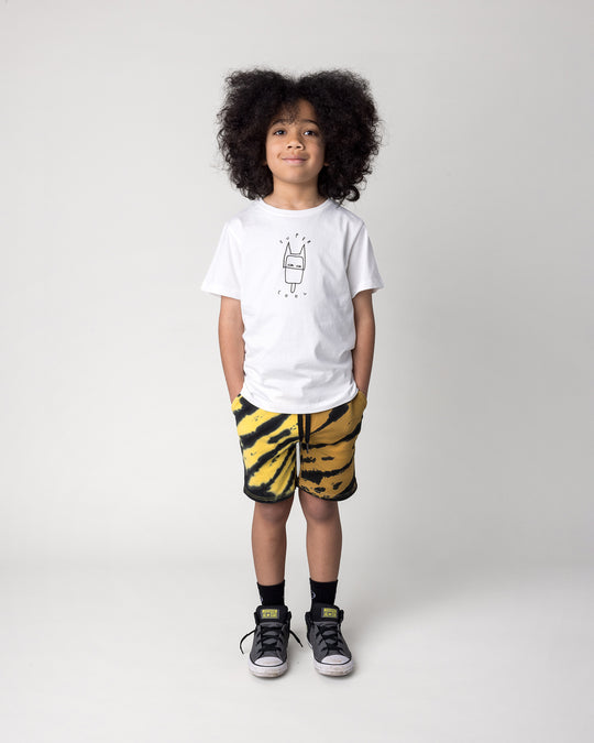 Kid wearing the Super Cool Tee in off white with the Duo Tie Dye Short in lemon and rust, front view