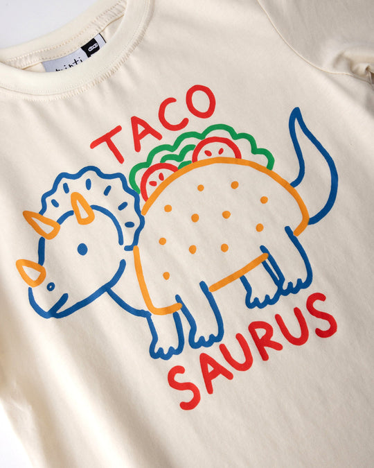Close up of the Taco Saurus Tee print in cream