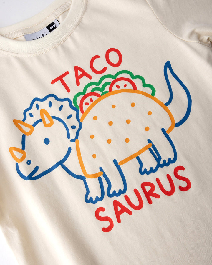 Close up of the Taco Saurus Tee print in cream