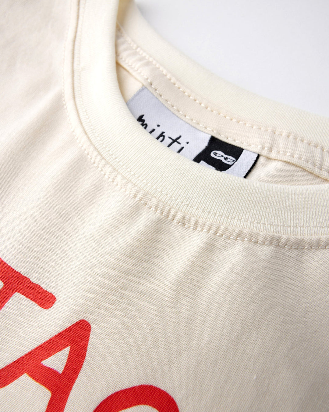 Close up detail of the Taco Saurus Tee in cream