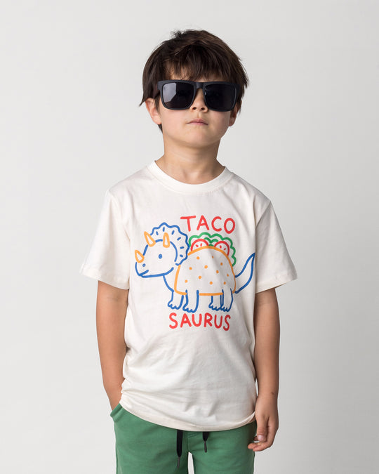 Close up of the Taco Saurus Tee in cream on a kid, front view