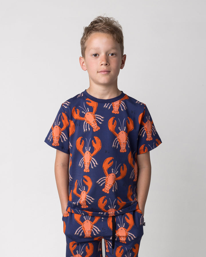 Close up of the Vacay Crayfish Tee in midnight on a kid, front view