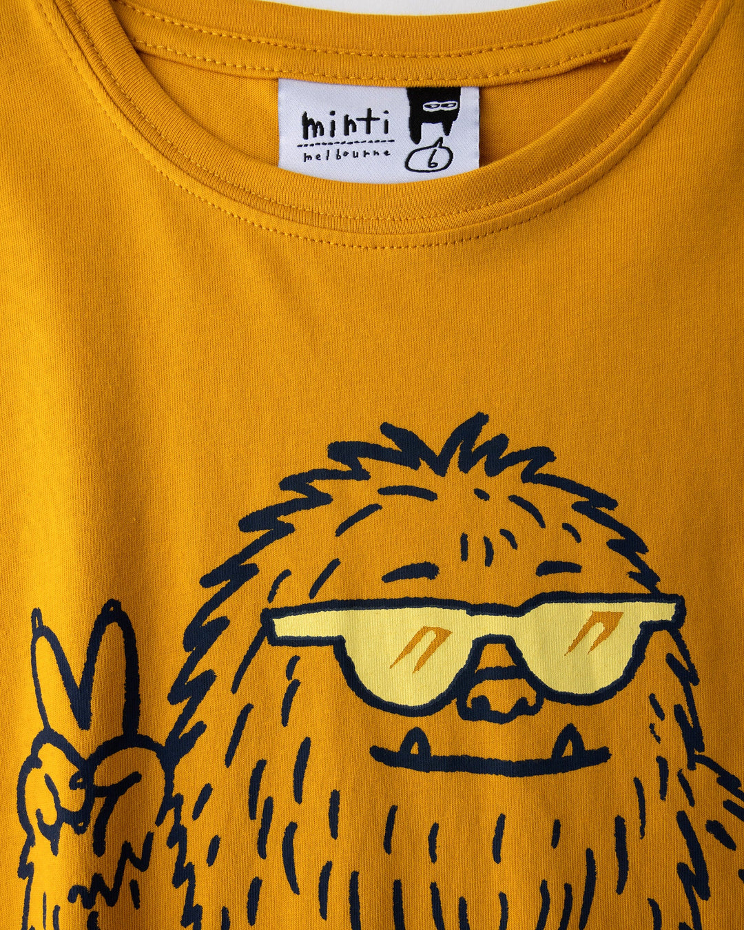 Close up of the Yo Yeti Tee print in mustard