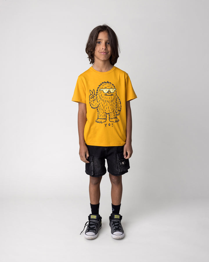 Kid wearing the Yo Yeti Tee in mustard, front view