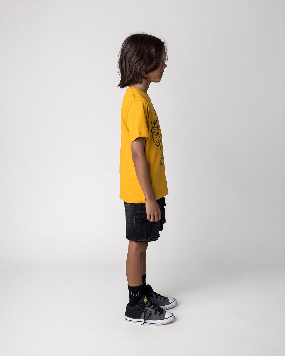 Kid wearing the Yo Yeti Tee in mustard, side view