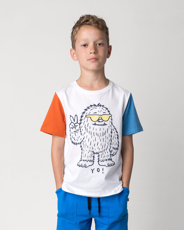 Close up of the Yo Yeti Tee in white, orange and steel on a kid, front view