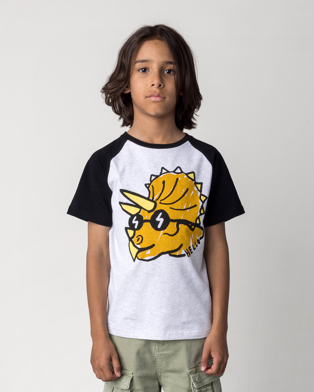 Close up of the Cool Dino Tee in white marle and black on a kid, front view