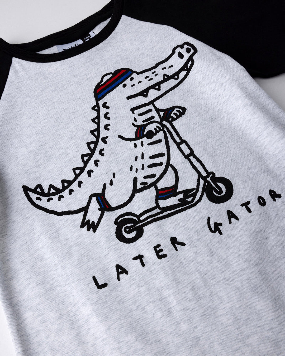 Close up of the Later Gator Tee print in white marle and black