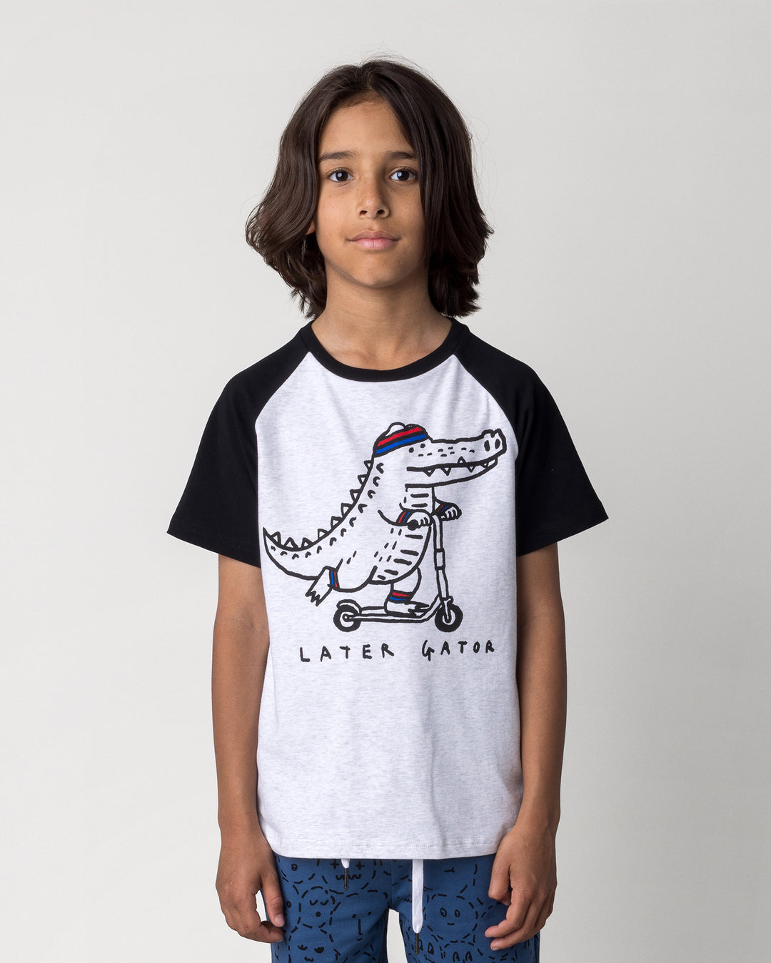 Close up of the Later Gator Tee in white marle and black on a kid, front view