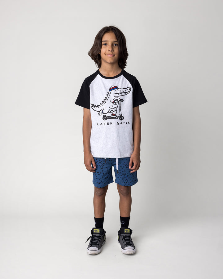 Kid wearing the Later Gator Tee in white marle and black with the Different Faces Short in midnight, front view