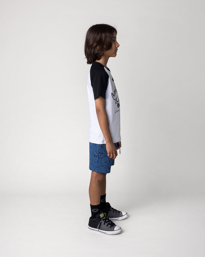 Kid wearing the Later Gator Tee in white marle and black with the Different Faces Short in midnight, side view