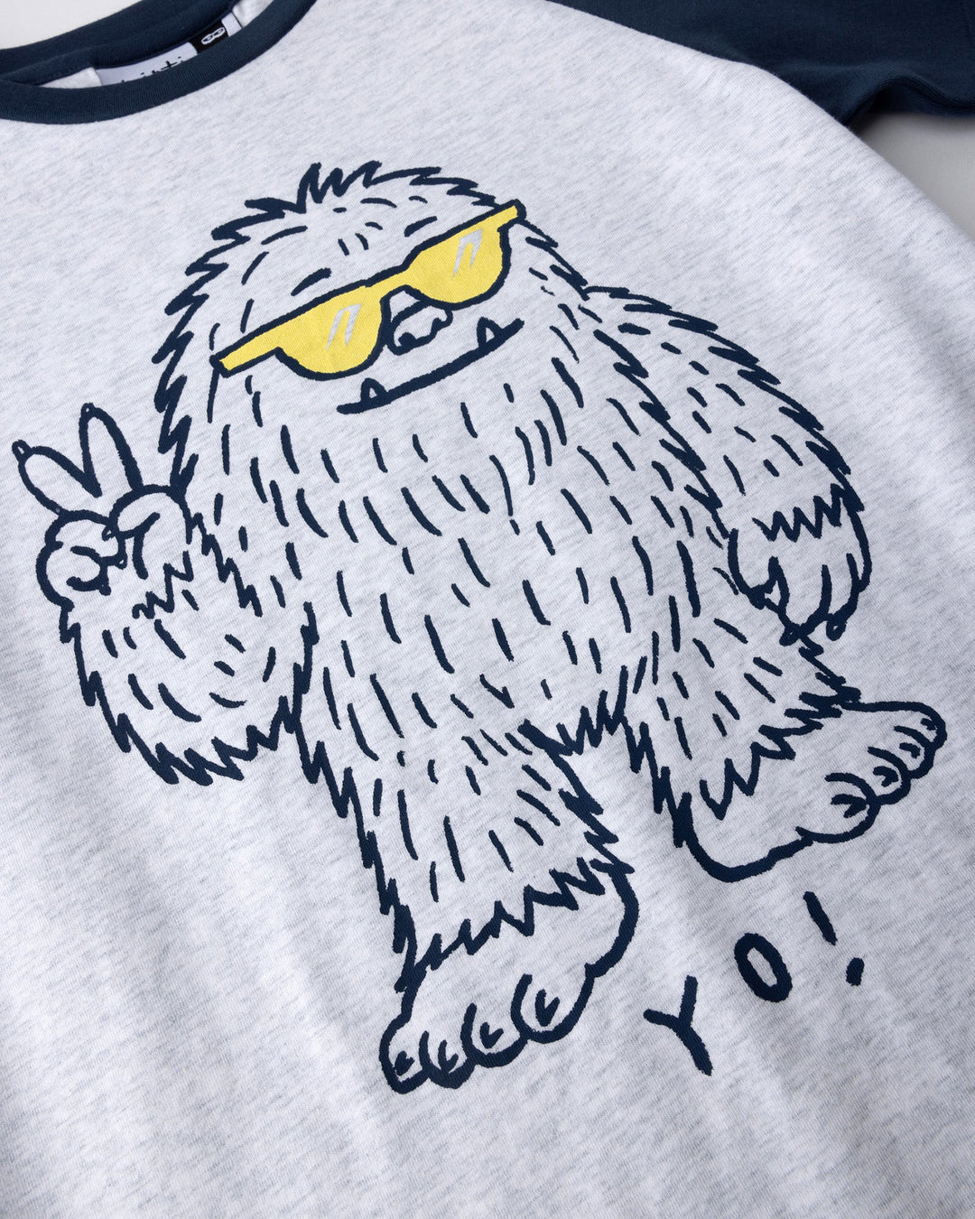 Close up of the Yo Yeti Tee print in white marle and ink