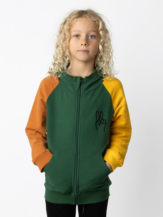 Minti kids clothing. Cosy zip through hoodie with kangaroo pockets for extra warmth! 2x2 rib trim on the hood, cuffs and hem. Small embroidery on the front and big print on the back. 330 Gram // Brushed Inside // 95% Cotton // 5% Elastane.