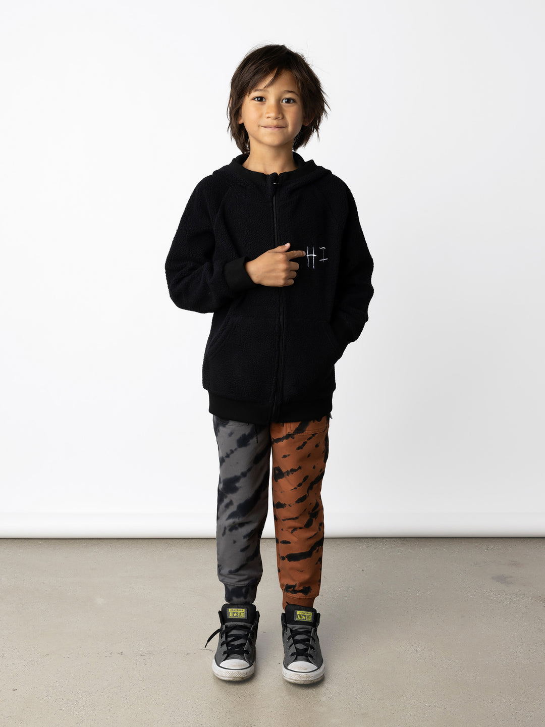 Minti kids clothing. Cosy zip through hoodie with kangaroo pockets for extra warmth! 2x2 rib trim on the hood, cuffs and hem. Small tonal Happy Face embroidery on the front. 330 Gram // Brushed Inside // 95% Cotton // 5% Elastane.
