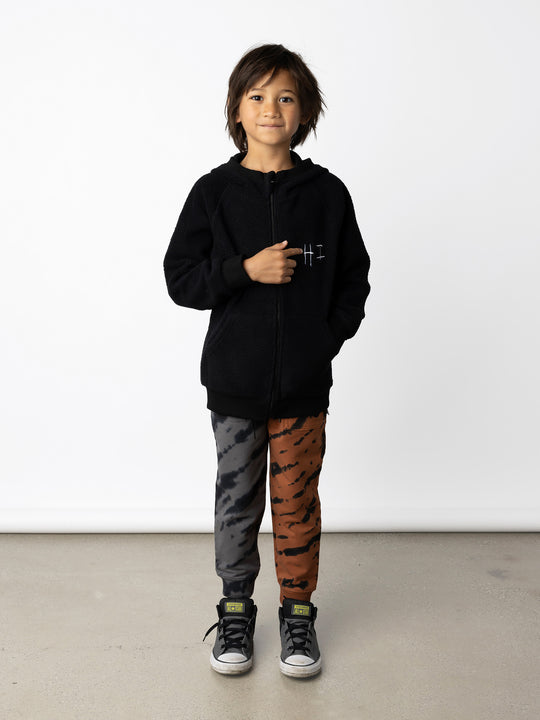 Minti kids clothing. Cosy zip through hoodie with kangaroo pockets for extra warmth! 2x2 rib trim on the hood, cuffs and hem. Small tonal Happy Face embroidery on the front. 330 Gram // Brushed Inside // 95% Cotton // 5% Elastane.