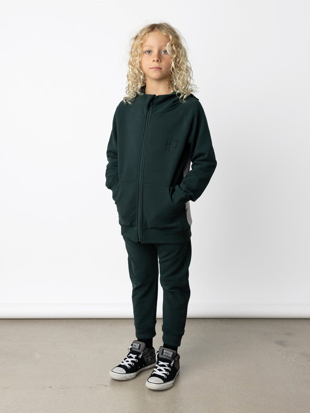 Minti kids clothing. Cosy zip through hoodie with kangaroo pockets for extra warmth! 2x2 rib trim on the hood, cuffs and hem. Small embroidery on the front and big print on the back. 330 Gram // Brushed Inside // 95% Cotton // 5% Elastane.