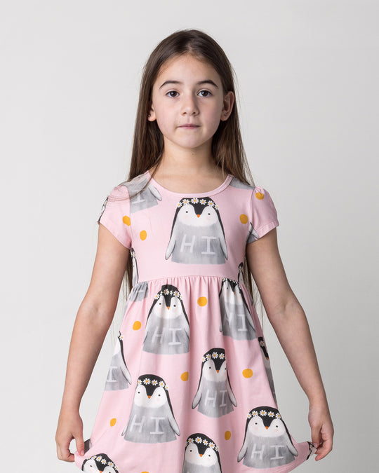 Close up of the Flower Penguin Dress in pink on a kid, front view