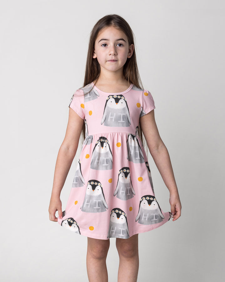 Close up of the Flower Penguin Dress in pink on a kid, front view