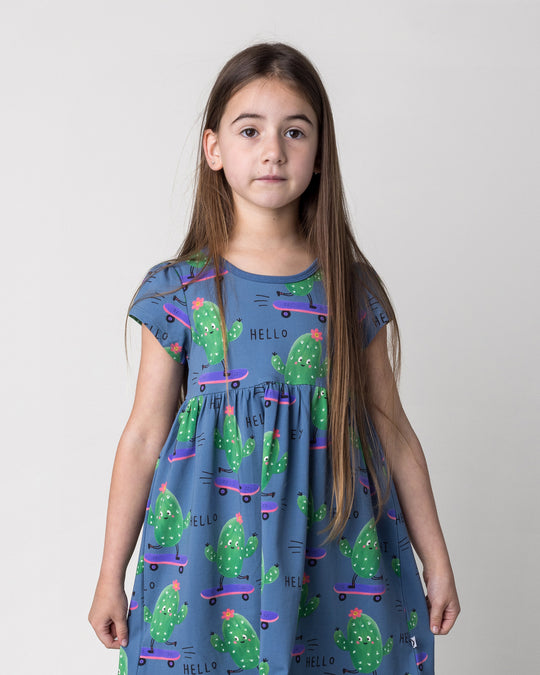 Close up of the Skate Cactus Dress in muted blue on a kid, front view