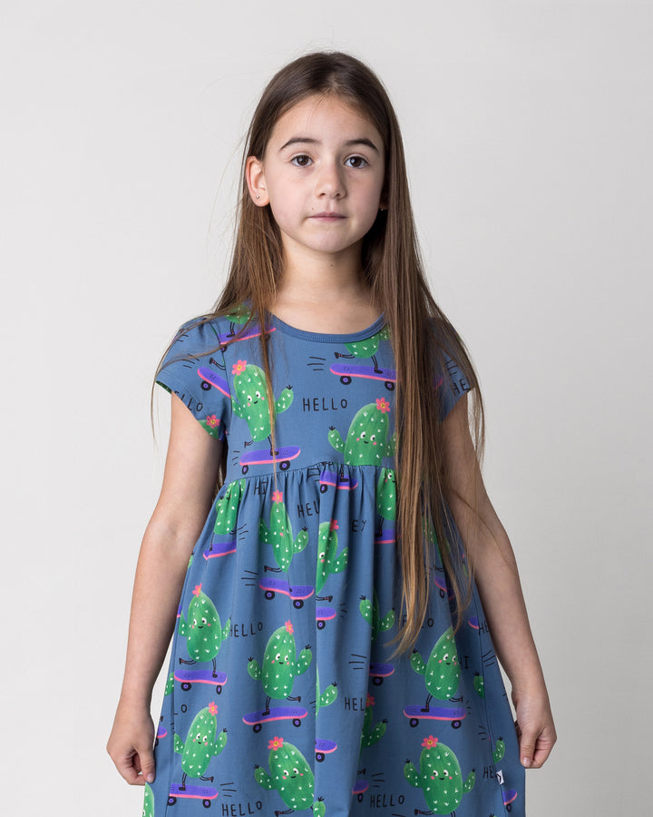 Close up of the Skate Cactus Dress in muted blue on a kid, front view